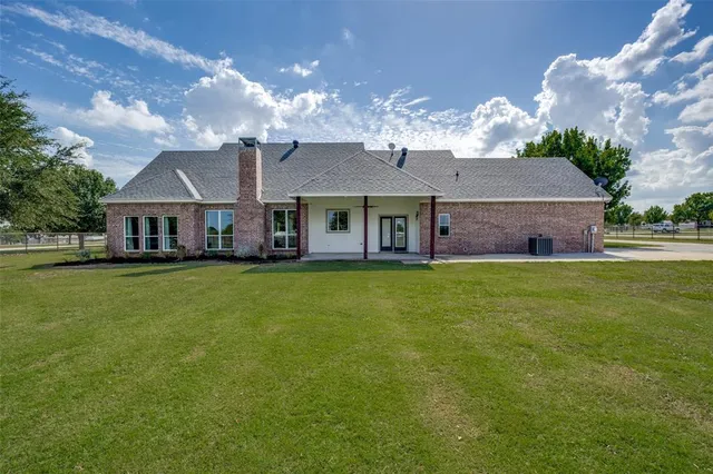 a front view of a house with a garden and plants