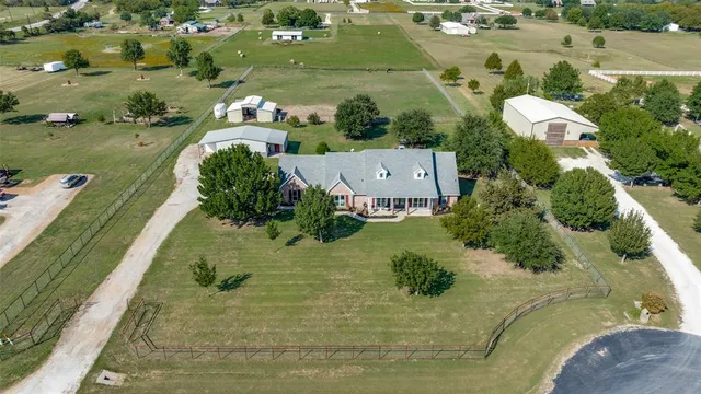 an aerial view of a house with a yard
