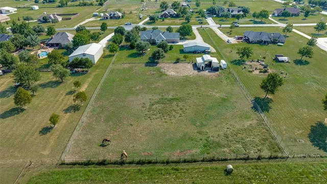 an aerial view of a residential houses with outdoor space and street view