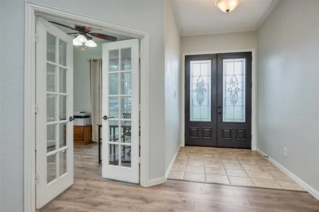 a view of a hallway with wooden floor and windows