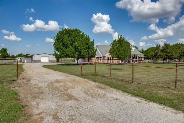 a front view of a house with a yard and a garage