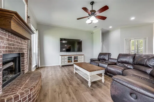 a living room with furniture a flat screen tv and a fireplace