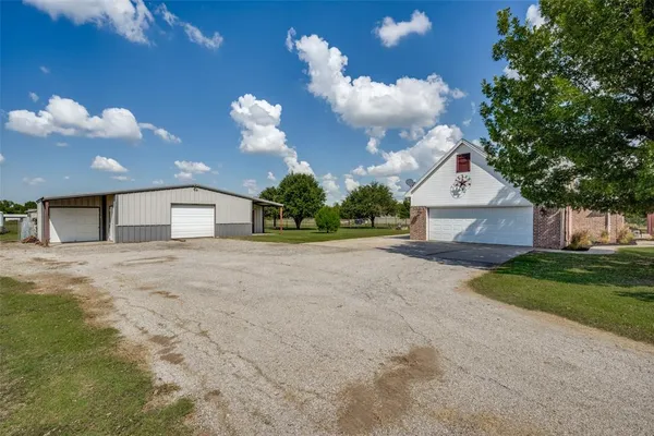 a view of garage and wooden fence
