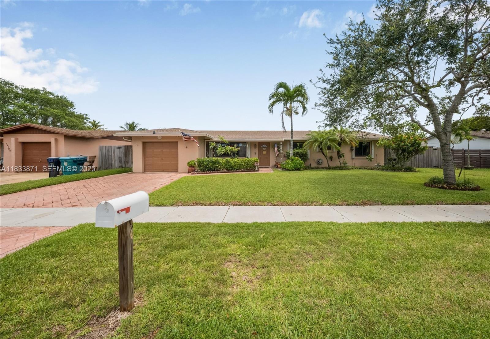 11193 Southwest 113th Terrace Miami, FL 33176 - Photo 1 of 43 a front view of a house with a yard