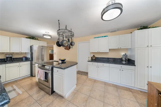 a kitchen that has a stove and a table in it