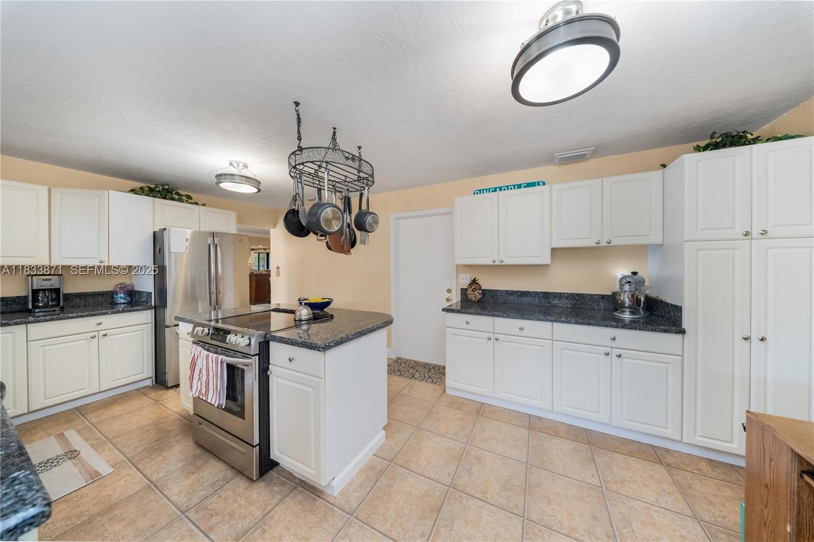 11193 Southwest 113th Terrace Miami, FL 33176 - Photo 11 of 43 a kitchen with a stove cabinets and white appliances