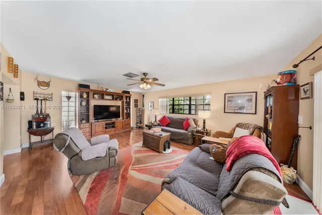 a living room with furniture and wooden floor
