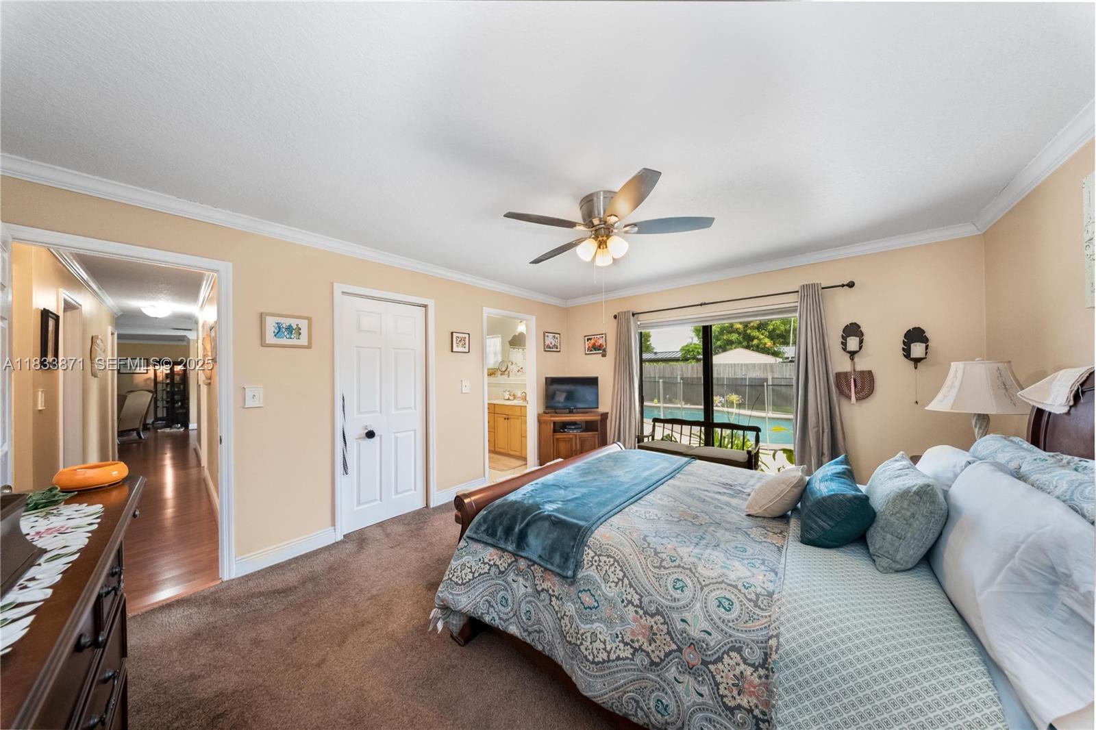 11193 Southwest 113th Terrace Miami, FL 33176 - Photo 21 of 43 a bedroom with a large bed and a chandelier