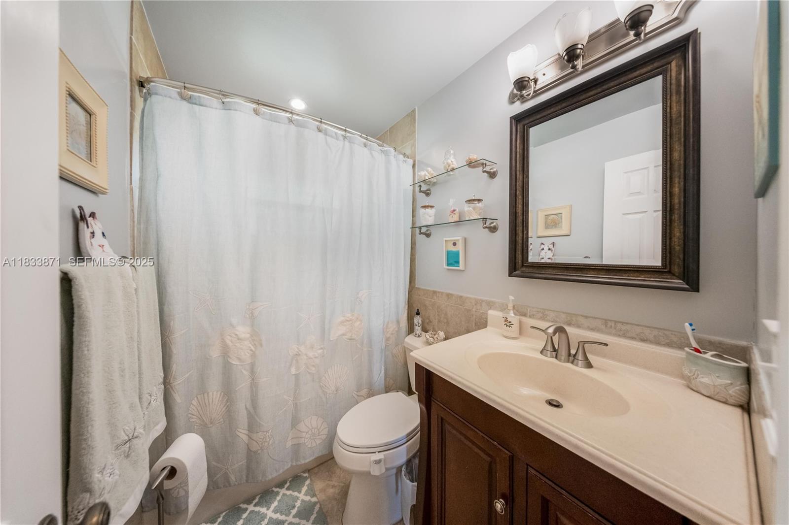 11193 Southwest 113th Terrace Miami, FL 33176 - Photo 28 of 43 a bathroom with a sink vanity mirror and toilet