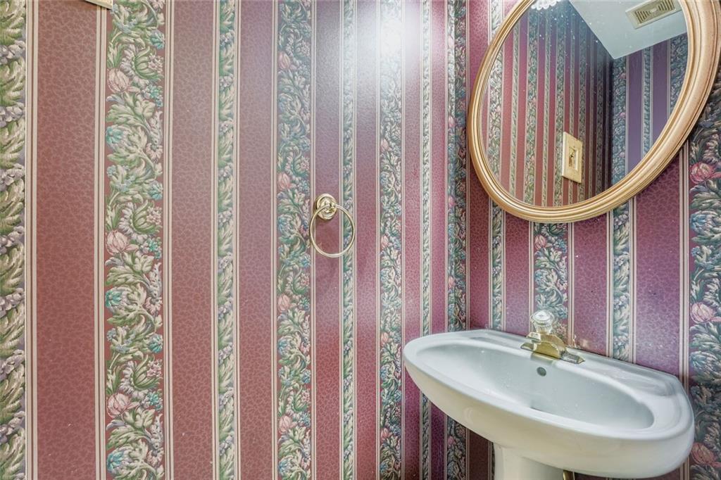 932 Huntsman Trace Lawrenceville, GA 30045 - Photo 12 of 30 a bathroom with a sink and a mirror