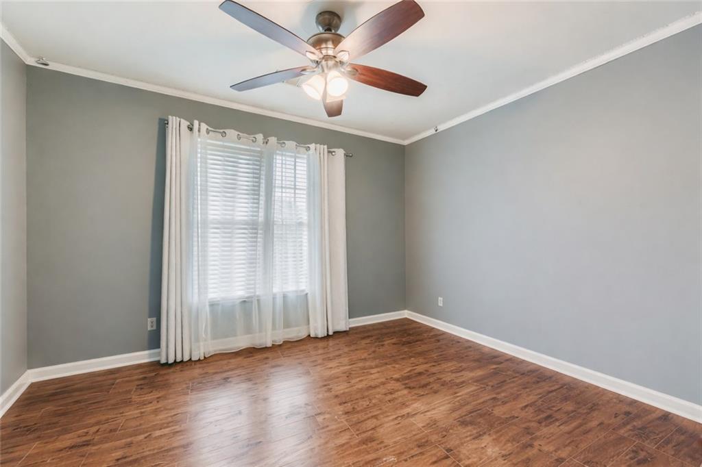 932 Huntsman Trace Lawrenceville, GA 30045 - Photo 19 of 30 an empty room with wooden floor fan and windows