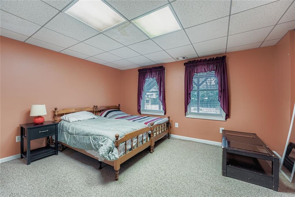 932 Huntsman Trace Lawrenceville, GA 30045 - Photo 24 of 30 a bed sitting in a room next to a window