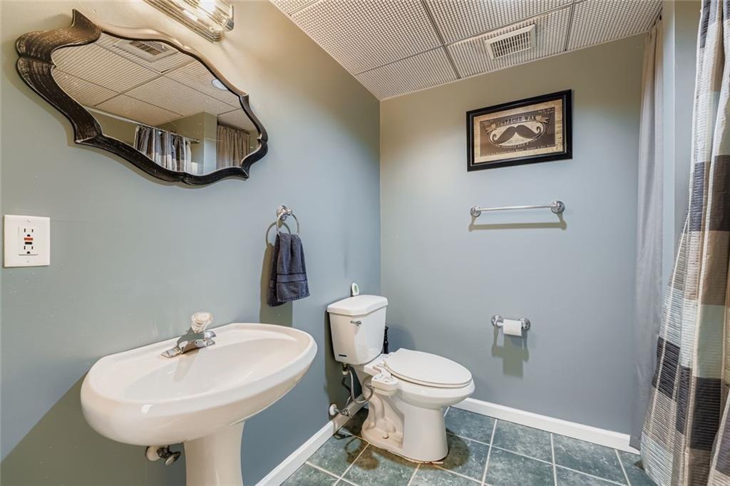 932 Huntsman Trace Lawrenceville, GA 30045 - Photo 25 of 30 a bathroom with a toilet sink and mirror