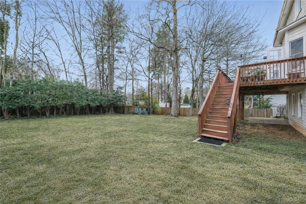 932 Huntsman Trace Lawrenceville, GA 30045 - Photo 26 of 30 a view of a house with a backyard