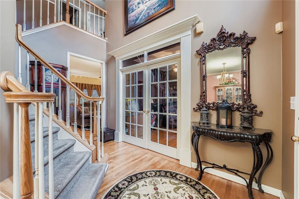 932 Huntsman Trace Lawrenceville, GA 30045 - Photo 3 of 30 a view of an entryway with wooden floor and a front door