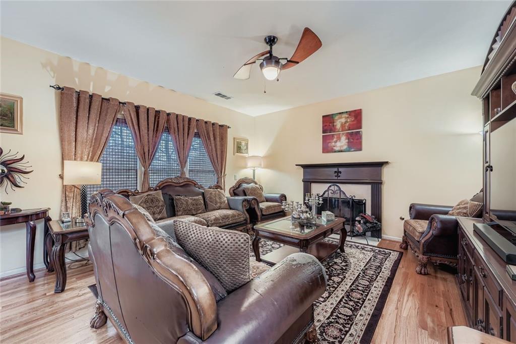 932 Huntsman Trace Lawrenceville, GA 30045 - Photo 4 of 30 a living room with furniture or couch and a fireplace