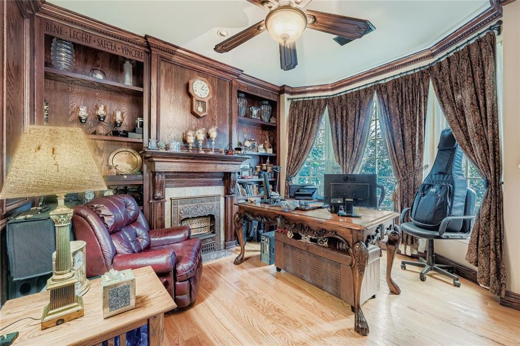 932 Huntsman Trace Lawrenceville, GA 30045 - Photo 7 of 30 a living room with furniture a fireplace and a chandelier