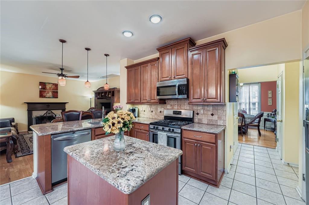 932 Huntsman Trace Lawrenceville, GA 30045 - Photo 10 of 30 a kitchen with stainless steel appliances granite countertop a stove top oven a sink a counter top space and cabinets