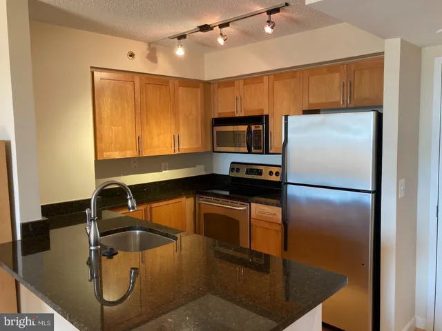 a kitchen with a refrigerator and a sink