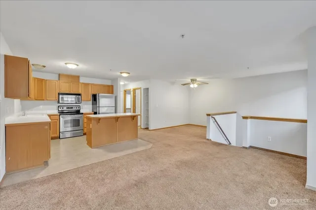 a view of kitchen with furniture and refrigerator