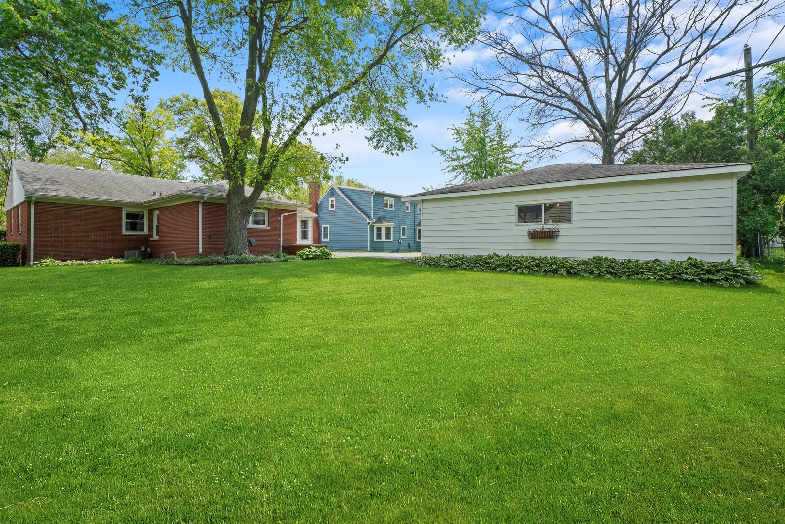 1350 Perry Street Crete, IL 60417 - Photo 17 of 17 a backyard of a house with plants and large tree