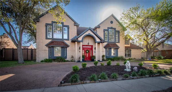 a front view of a house with a yard and outdoor seating