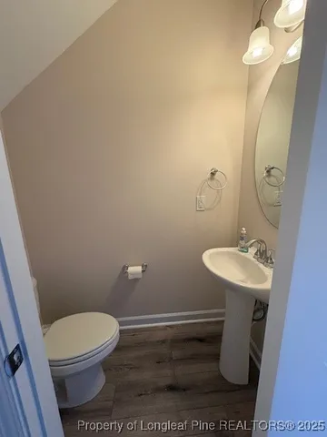 a bathroom with a sink a toilet a mirror and vanity