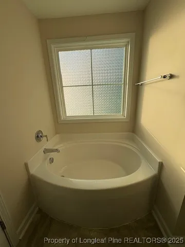 a white bath tub sitting next to a window