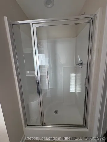 a bathroom with a glass shower door