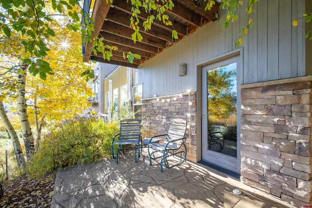a view of a patio with table and chairs and potted plants