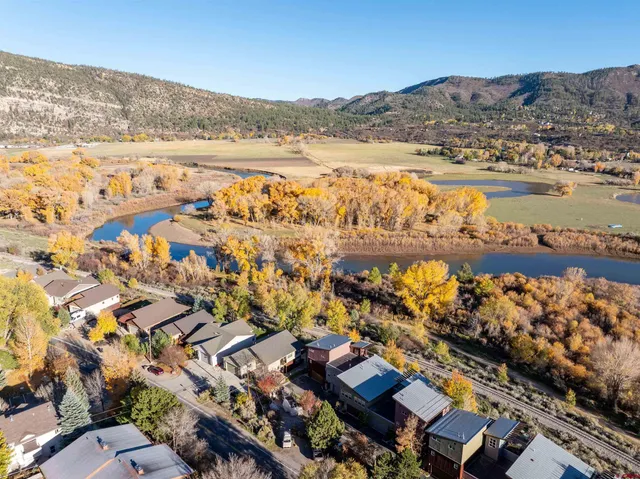 an aerial view of a house with a yard swimming pool and outdoor seating