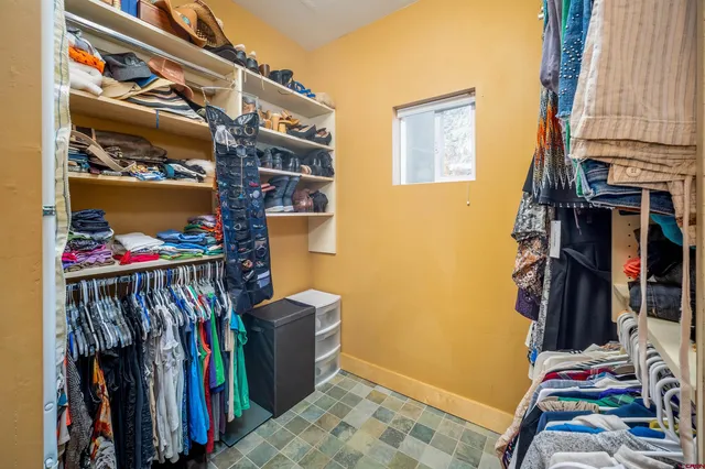 a view of walk in closet with clothes