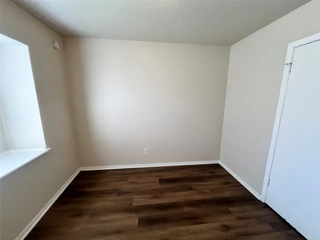 a view of room with wooden floor