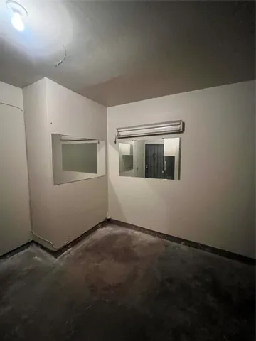 a view of an empty room with windows