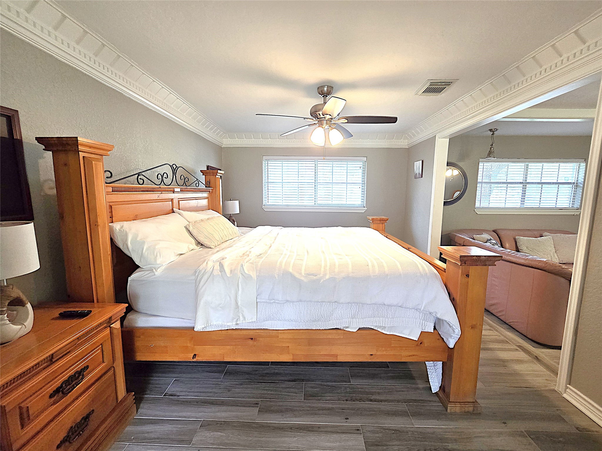 560 Brandon Road Conroe, TX 77302 - Photo 28 of 45 Spacious and inviting primary bedroom with ample natural light, elegant molding, and a cozy sitting area. Perfect for relaxation and comfort.