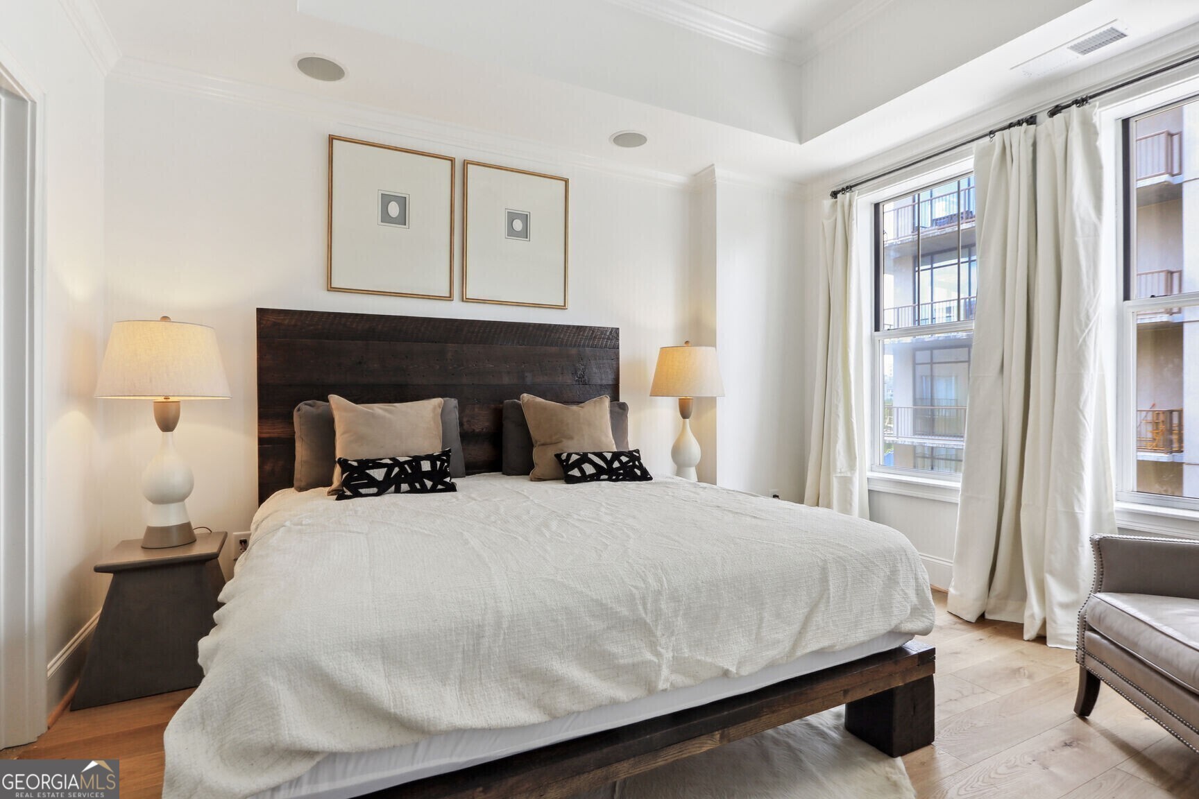 2255 Peachtree Road Northeast, Unit 825 Atlanta, GA 30305 - Photo 12 of 15 a bedroom with a bed and wooden floor