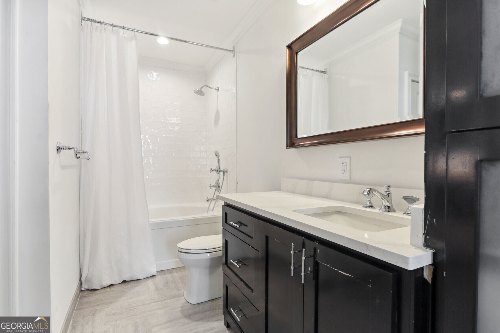 2255 Peachtree Road Northeast, Unit 825 Atlanta, GA 30305 - Photo 14 of 15 a bathroom with a granite countertop sink toilet and shower