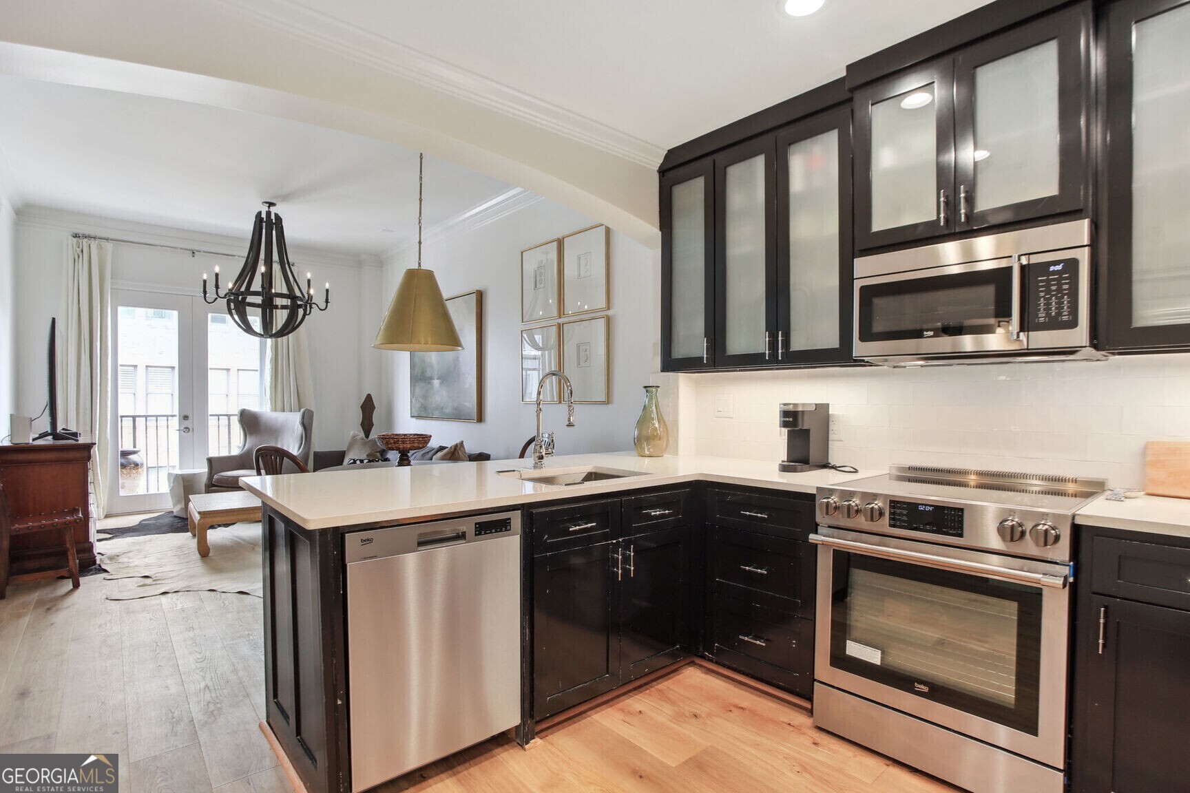 2255 Peachtree Road Northeast, Unit 825 Atlanta, GA 30305 - Photo 3 of 15 a kitchen with stainless steel appliances a stove sink microwave and cabinets