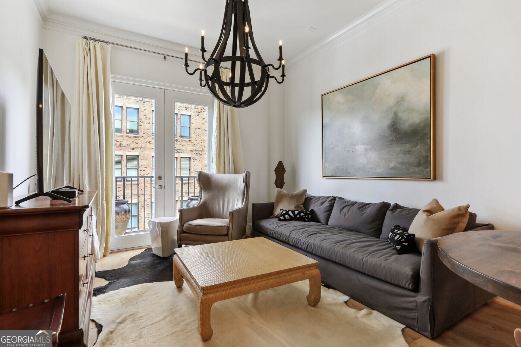 2255 Peachtree Road Northeast, Unit 825 Atlanta, GA 30305 - Photo 4 of 15 a living room with furniture a large window and a chandelier