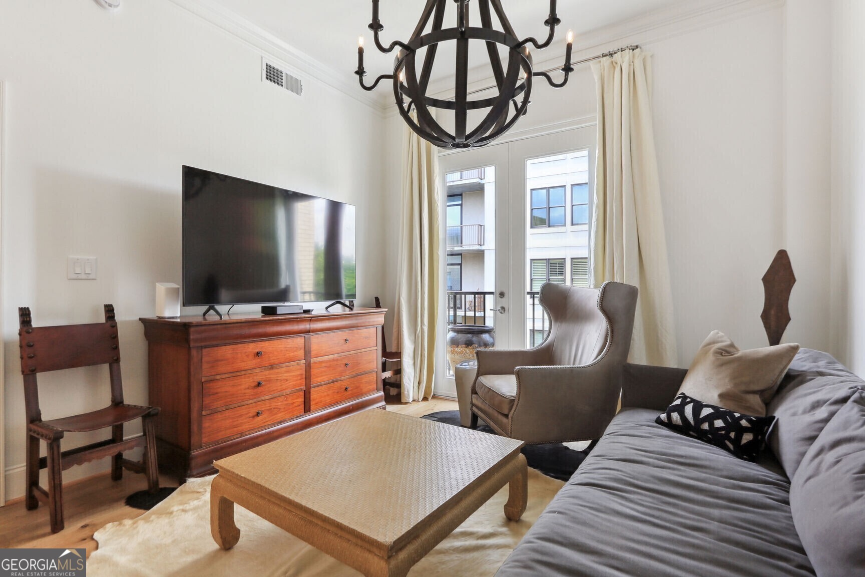 2255 Peachtree Road Northeast, Unit 825 Atlanta, GA 30305 - Photo 5 of 15 a living room with furniture and a flat screen tv