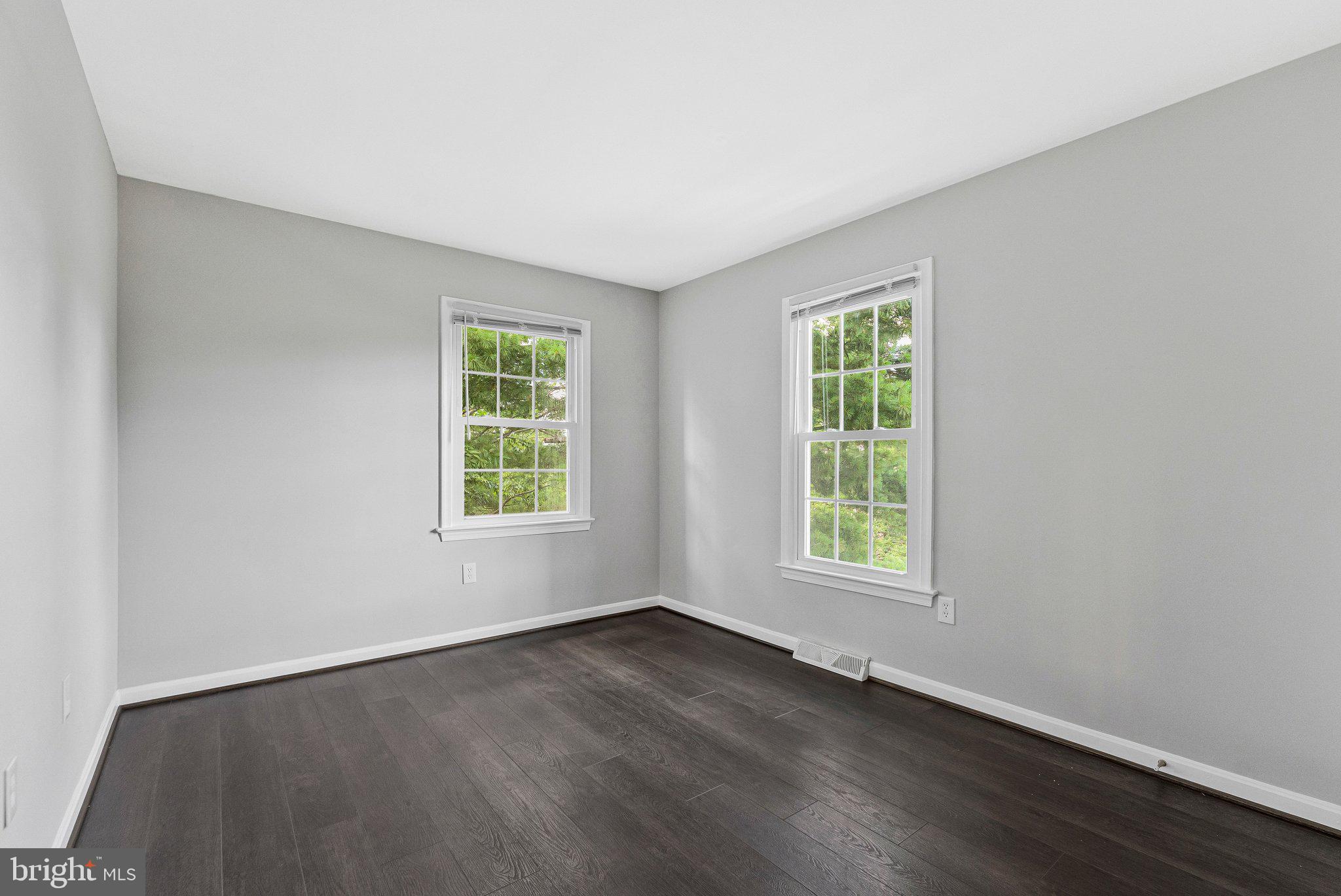 2000 Gallows Tree Lane Vienna, VA 22182 - Photo 31 of 58 a view of an empty room with wooden floor and a window