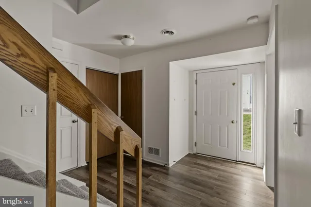 a view of entryway with wooden floor and stairs