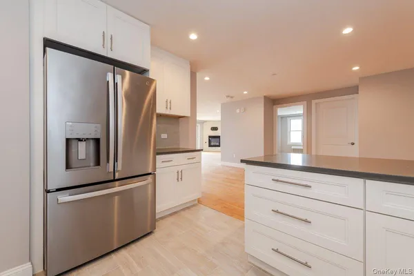 a kitchen with white cabinets and stainless steel appliances