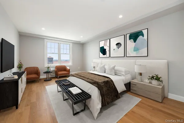 a spacious bedroom with a bed and glass windows