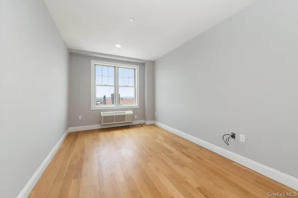 a view of a room with wooden floor and window