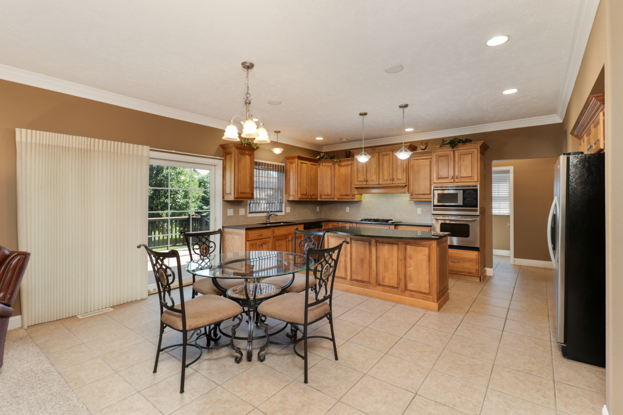 4012 Rockledge Road Bloomington, IL 61705 - Photo 19 of 63 a kitchen with stainless steel appliances kitchen island granite countertop a refrigerator and a stove top oven