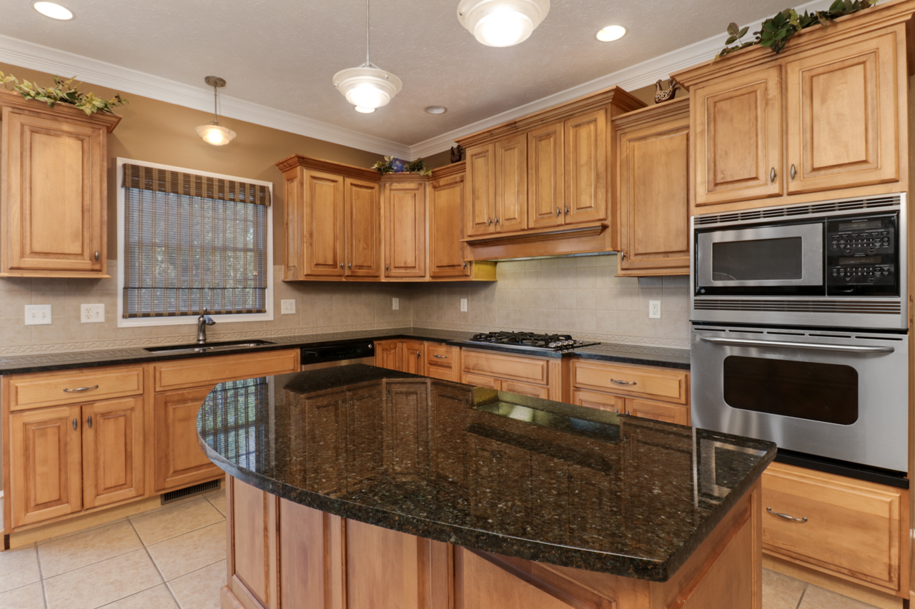 4012 Rockledge Road Bloomington, IL 61705 - Photo 20 of 63 a kitchen with granite countertop a stove sink and cabinets