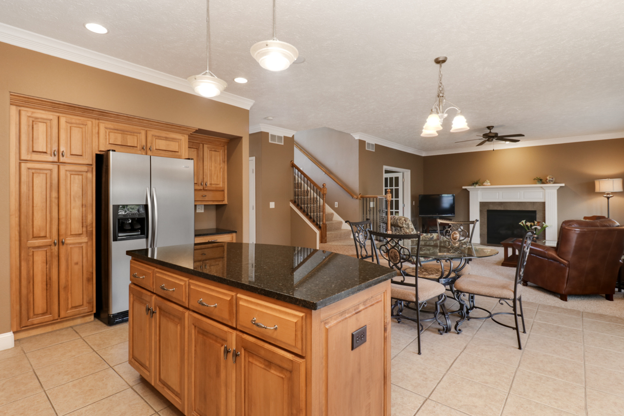 4012 Rockledge Road Bloomington, IL 61705 - Photo 21 of 63 a kitchen with stainless steel appliances granite countertop a refrigerator a oven a stove and a sink with couches