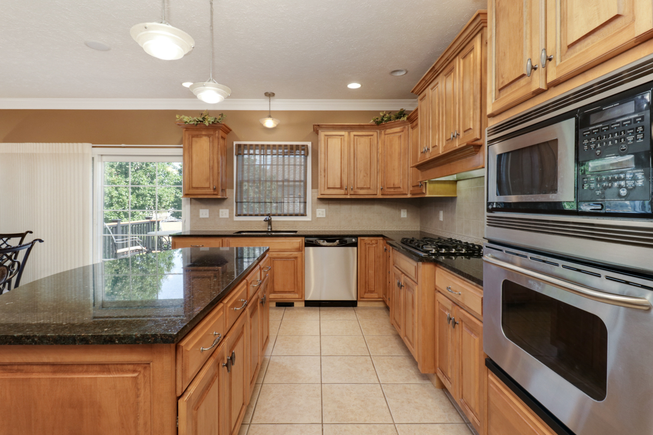 4012 Rockledge Road Bloomington, IL 61705 - Photo 25 of 63 a kitchen with stainless steel appliances granite countertop a stove a sink and a microwave