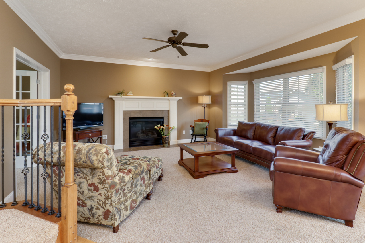 4012 Rockledge Road Bloomington, IL 61705 - Photo 26 of 63 a living room with furniture fireplace and a flat screen tv
